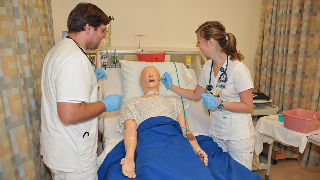 Students working on a dummy