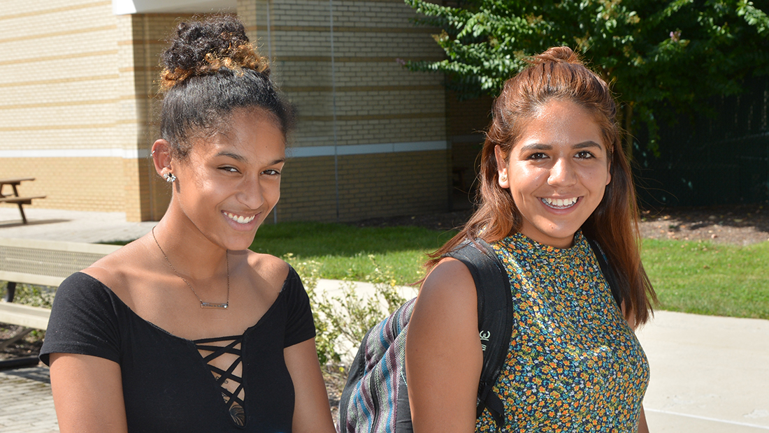 Two female students outside smiling