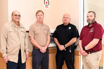 From left, Wor-Wic Community College employee Ronald Carey with the colleagues who helped him survive a heart attack: Gene Dyson, Linnie Vann and Daniel R. Webster Jr. Knowing CPR and how to use an AED helped them save Carey’s life.