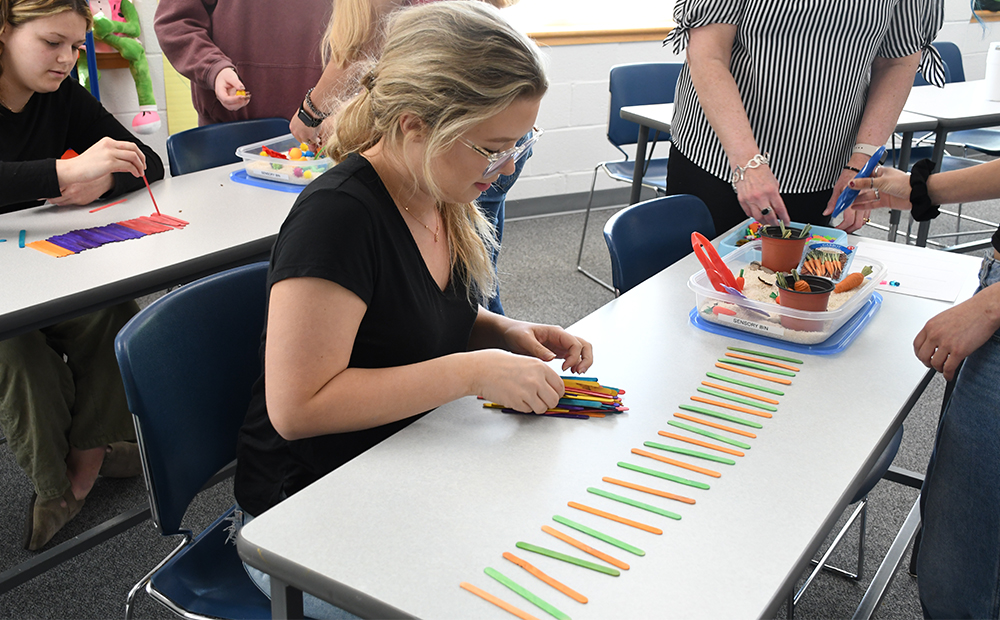 education student working with popsicle sticks