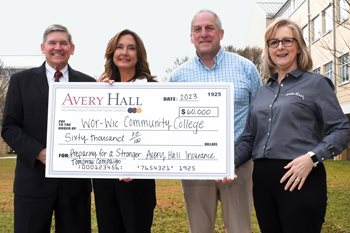 From left, Dr. Ray Hoy, president of Wor-Wic Community College, and Stefanie K. Rider, executive director of the foundation and director of development, accept a pledge of $60,000 for the college’s “Preparing for a Stronger Tomorrow” campaign from Joseph Gast, president of Avery W. Hall Insurance Agency, and Maureen Cody, commercial lines account executive