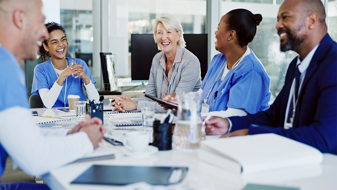 medical and nonmedical personnel around a table